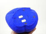 someone is holding a blue ball in their hand on a white background