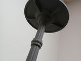 a metal pole that has a light on top of it