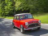 a small red car driving down the road with trees in the background