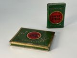 two tins of cigarettes sitting next to each other on a table