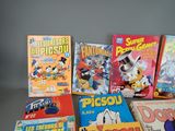 a lot of comic books that are on the table