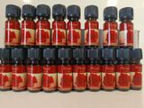 several bottles of rose essential oil sitting on top of a table