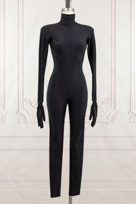 a mannequin in a black bodysuit on a mannequin stand