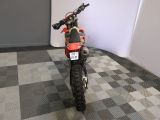 a dirt bike that is parked in a room