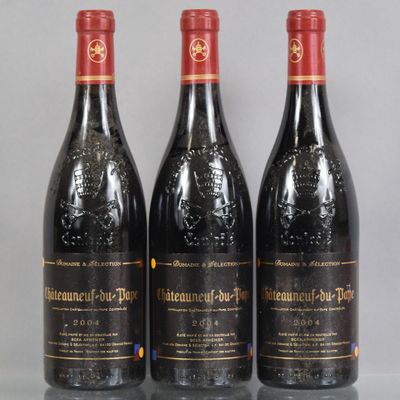 three bottles of red wine sitting on top of a glass table