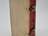 a small book that is open on a white surface
