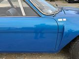 an image of a blue car parked in a lot