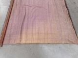 a pink blanket that is laying on the floor