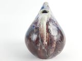 a small vase that is sitting on a white surface
