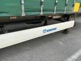 un camion vert et blanc garé sur un parking