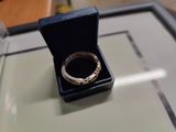 a silver ring in a black box on a table