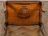 a wooden box with a sign on it on the floor