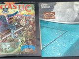 two comics on the table next to a toaster