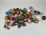 a pile of assorted glass beads on a white surface