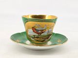 a cup and saucer with a picture of a bird on it