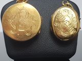 two gold lockes on display on a black display case