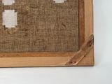 a picture of a cross stitch picture on a piece of burlock