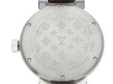 the back of a watch with a silver dial and brown leather strap