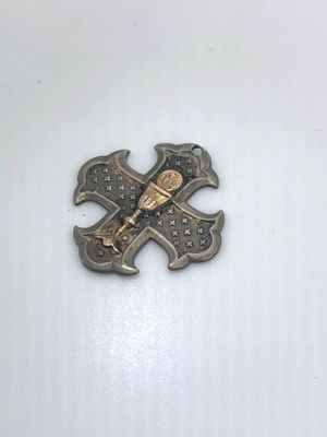 a metal pin with a baseball bat and a baseball bat on it