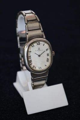 a close up of a wrist watch on a stand
