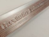 an image of a close up of a metal tube with writing on it