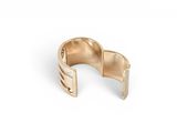 a close up of a gold ring on a white background