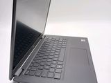 a laptop that is open on a white surface