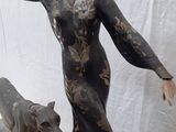 a statue of a woman and two dogs on a glass table