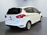 the rear end of a white ford c - max parked in a garage