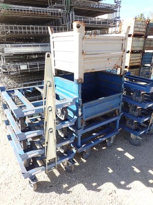 a truck that is sitting next to a pile of pallets