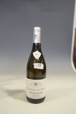 a bottle of wine sitting on a table next to a glass of wine