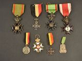 several medals and medals are displayed on a black surface
