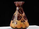 a vase that is sitting on a table with a black background