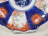 a blue and red plate with a picture of a bird on it