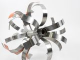 a metal sculpture of a flower that is on a table