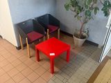 three chairs and a table in the corner of a room