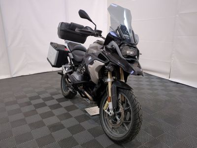 a motorcycle that is parked on a black and white checkered floor