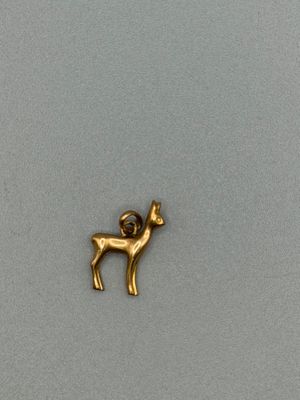 a close up of a gold plated animal on a gray surface