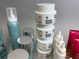 many different types of skin care products sitting on a table