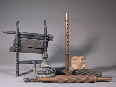 a wooden chair, a chair, and other objects on a table