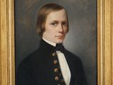 portrait of a man in a black coat and white shirt