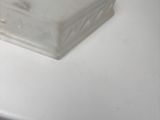 a plastic container sitting on top of a white counter