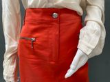 an image of a mannequin wearing a white shirt and red skirt