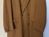 an image of a coat hanging on a hanger in a room