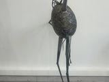 bronze sculpture of a bird with a long neck and legs