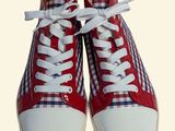pair of red and white sneakers with white laces on a white background