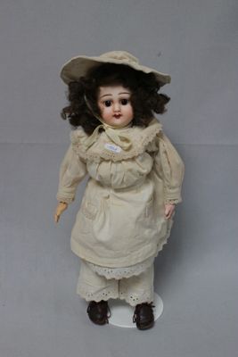 a doll that is wearing a hat and dress