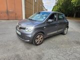 the small car is parked on the side of the road