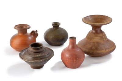 four vases that are sitting on a white surface