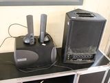 two speakers sitting on top of a table with a speaker on it